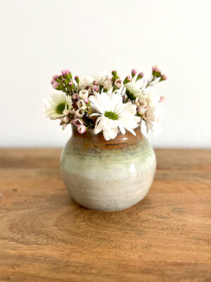 Pretty pottery vase with spring flowers